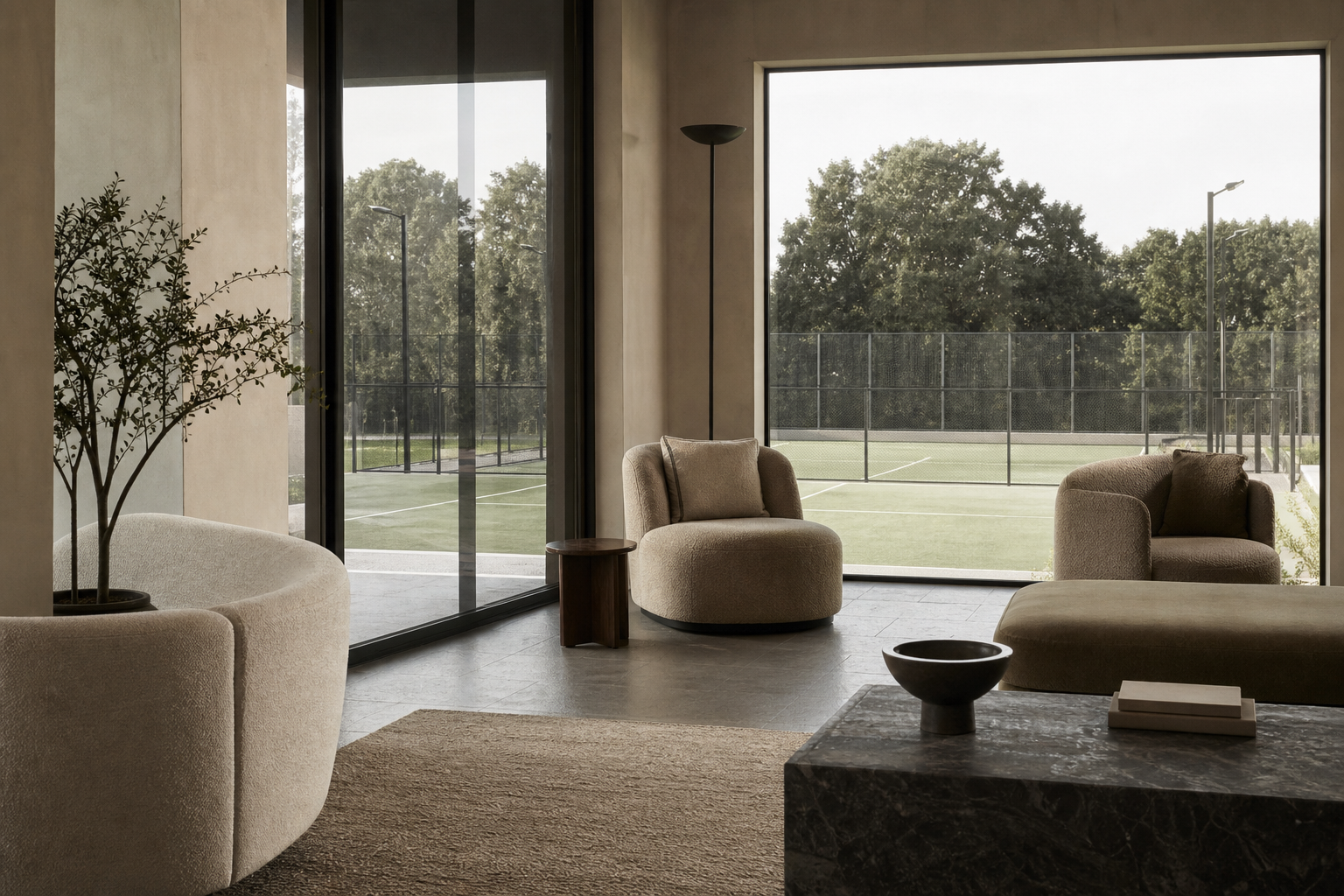 Hotel social lounge with windows framing an outdoor padel court