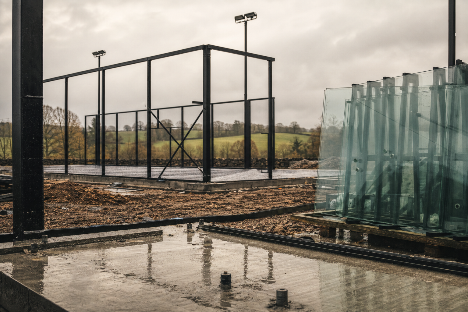 Padel court under construction with steel frame and foundations in the UK